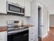 Well-equipped kitchen with stainless steel oven, microwave, and ample cabinetry at 427 Watson Rd, Efland, NC 27243