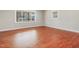 Sun-filled living room featuring hardwood floors, neutral paint, and large windows at 427 Watson Rd, Efland, NC 27243
