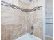 Shower features neutral tile with decorative accent border, new fixtures and bright lighting at 427 Watson Rd, Efland, NC 27243