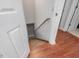 Stairwell with hardwood flooring and white trim, leading to lower level at 427 Watson Rd, Efland, NC 27243