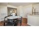 Cozy dining area with a modern table, stainless steel refrigerator, and hardwood floors at 4705 Blue Bird Ct # C, Raleigh, NC 27606