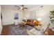 Bright living room boasts a stylish rug, comfortable seating, and a ceiling fan at 4705 Blue Bird Ct # C, Raleigh, NC 27606