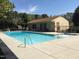 Community pool with clear blue water, surrounded by ample seating and a clubhouse for resident enjoyment at 4705 Blue Bird Ct # C, Raleigh, NC 27606