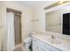 A bright bathroom featuring a shower, toilet, large sink and mirror with lighting above at 6312 New Market Way, Raleigh, NC 27615