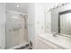 Bathroom featuring shower with sliding door, vanity sink, and updated lighting at 6312 New Market Way, Raleigh, NC 27615