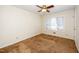 A bedroom with brown carpet, window with blinds, and a wooden ceiling fan at 6312 New Market Way, Raleigh, NC 27615
