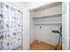 Bathroom closet with floral shower curtain and open shelving at 6312 New Market Way, Raleigh, NC 27615
