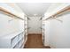 A well organized walk-in closet with shelving, hanging bars and carpeted floor at 6312 New Market Way, Raleigh, NC 27615