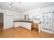 Kitchen boasts white cabinets, granite countertops, and wood flooring at 6312 New Market Way, Raleigh, NC 27615
