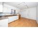 Kitchen boasts white cabinets, granite countertops, and wood flooring at 6312 New Market Way, Raleigh, NC 27615