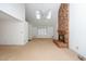 Bright living room boasts a brick fireplace, skylights, and neutral carpeting at 6312 New Market Way, Raleigh, NC 27615