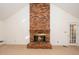 Living room featuring a floor-to-ceiling brick fireplace and a vaulted ceiling at 6312 New Market Way, Raleigh, NC 27615