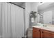 Bathroom with a vanity, framed mirror, and shower with gray striped curtain at 642 Thistle Dr, Burlington, NC 27217