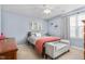 Comfortable bedroom with ceiling fan, large window and decorative furnishings at 642 Thistle Dr, Burlington, NC 27217