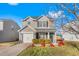 Charming two-story home features a well-maintained front yard with vibrant landscaping and a one-car garage at 642 Thistle Dr, Burlington, NC 27217