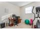 Comfortable office space with desk, elliptical machine and large window for natural light at 642 Thistle Dr, Burlington, NC 27217
