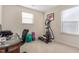 Well-lit office featuring carpet, elliptical machine, yoga ball, and desk with chair at 642 Thistle Dr, Burlington, NC 27217
