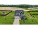 Stunning aerial view of a charming two-story home surrounded by lush landscaping and a scenic pond at 6804 Arlington Oaks Trl, Raleigh, NC 27603