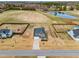 Picturesque aerial view showcasing the home's location near a pond and surrounded by large, open fields at 6804 Arlington Oaks Trl, Raleigh, NC 27603