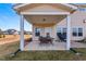 Backyard features covered patio with table and grill; ideal for outdoor gatherings with spacious lawn at 6804 Arlington Oaks Trl, Raleigh, NC 27603
