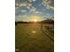 Scenic backyard view with a seating area and a sunset over a beautiful field at 6804 Arlington Oaks Trl, Raleigh, NC 27603