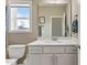 Well-lit bathroom featuring a vanity with a white countertop and a view to the outdoors at 6804 Arlington Oaks Trl, Raleigh, NC 27603