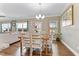 Open-concept dining area with wood floors, decorative lighting, and large windows for ample natural light at 6804 Arlington Oaks Trl, Raleigh, NC 27603