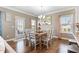 Bright dining area features wood table with seating for eight and a view of the backyard at 6804 Arlington Oaks Trl, Raleigh, NC 27603