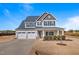 Two-story home features a covered porch, well-maintained lawn, and a spacious three-car garage at 6804 Arlington Oaks Trl, Raleigh, NC 27603