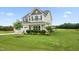 Beautiful home featuring a well-kept lawn and landscaping with flowering bushes and manicured shrubbery at 6804 Arlington Oaks Trl, Raleigh, NC 27603