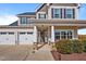 Inviting front entrance featuring a welcoming porch, manicured landscaping, and a two-car garage at 6804 Arlington Oaks Trl, Raleigh, NC 27603