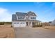 Charming two-story home featuring a well-manicured lawn, two-car garage, and inviting front porch at 6804 Arlington Oaks Trl, Raleigh, NC 27603