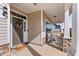 Charming covered front porch with stone accents, welcome mat, and neutral siding provides a warm welcome at 6804 Arlington Oaks Trl, Raleigh, NC 27603