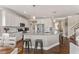 Open kitchen featuring granite counters, stainless steel appliances, and a convenient island at 6804 Arlington Oaks Trl, Raleigh, NC 27603