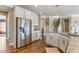 Spacious kitchen with stainless steel refrigerator and view to the staircase at 6804 Arlington Oaks Trl, Raleigh, NC 27603