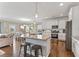 Open kitchen with granite counters, stainless steel appliances, and an island with seating at 6804 Arlington Oaks Trl, Raleigh, NC 27603