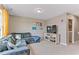 Spacious living room featuring a sectional sofa, TV, and modern décor at 6804 Arlington Oaks Trl, Raleigh, NC 27603