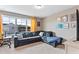Comfortable living room with a sectional sofa, large window, and stylish decorations at 6804 Arlington Oaks Trl, Raleigh, NC 27603