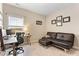 Comfortable office space with a sofa, desk, and window, creating a productive and relaxing environment at 6804 Arlington Oaks Trl, Raleigh, NC 27603