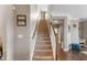 Carpeted staircase with white wooden railing leading to the upper level of the home at 6804 Arlington Oaks Trl, Raleigh, NC 27603