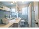 Bathroom with a tiled floor and walls, toilet, sink, and shower at 708 Kenmore Rd, Chapel Hill, NC 27514