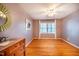 Bright bedroom with light purple walls and hardwood floors, features a modern ceiling fan and lots of natural light at 708 Kenmore Rd, Chapel Hill, NC 27514
