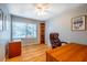 Comfortable bedroom featuring hardwood floors, a ceiling fan, a desk, and natural light streaming through the window at 708 Kenmore Rd, Chapel Hill, NC 27514
