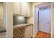 Cozy butler pantry features granite countertops, backsplash, wine rack and white cabinetry at 708 Kenmore Rd, Chapel Hill, NC 27514