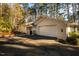 Exterior view of a beautiful brick home with a two-car garage and a well-manicured driveway at 708 Kenmore Rd, Chapel Hill, NC 27514