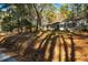 Ranch-style home featuring a well-maintained lawn, mature trees, and a beautiful exterior at 708 Kenmore Rd, Chapel Hill, NC 27514