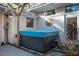 Backyard hot tub area with neutral brick, an outdoor shower, and a wood pergola at 708 Kenmore Rd, Chapel Hill, NC 27514