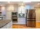 Kitchen with granite counters, stainless appliances, and ample cabinet space at 708 Kenmore Rd, Chapel Hill, NC 27514
