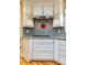 Kitchen features granite counters, tiled backsplash, and stainless vent hood at 708 Kenmore Rd, Chapel Hill, NC 27514