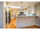 Bright eat-in kitchen featuring white cabinetry, stainless appliances, granite countertops, and hardwood floors at 708 Kenmore Rd, Chapel Hill, NC 27514